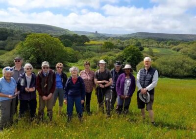 The walking group hosted walkers from Colchester and Photo of walkers with Corfe Castle in the distance – May 15, 2024
