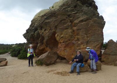 Photo of walkers taking a rest at Agglestone Rock – June 8, 2024