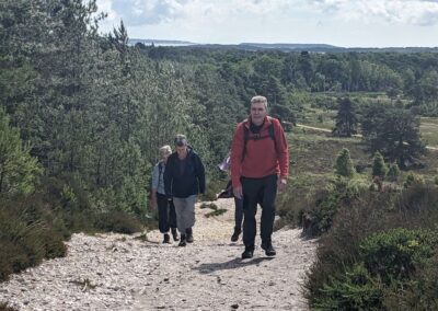 Photo of walkers ascending the side of Great Ovens Hill – June 15, 2024