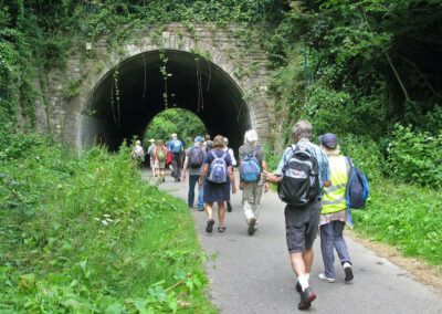 Photo of walkers entering a disused railway tunnel on the Rodwell Trail – July 13, 2024