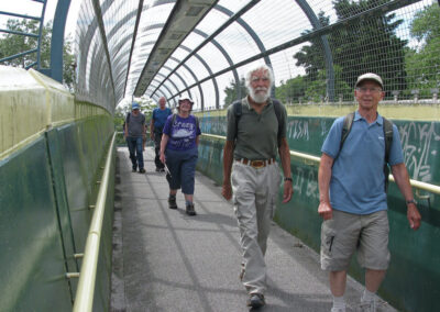 Photo of walkers crossing the railway on the way to Radipole Lake Bird Reserve – July 13, 2024