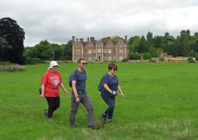 Photo of walkers passing Breamore House – July 24, 2024