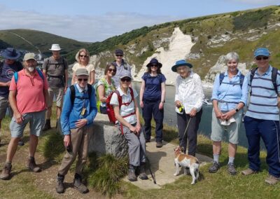 Walking group photographed with Lulworth Cove in the background – August 17, 2024