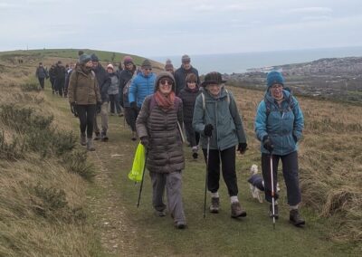 Photo of 33 walkers Nine Barrow Down with Swanage in the distance – January 4, 2025