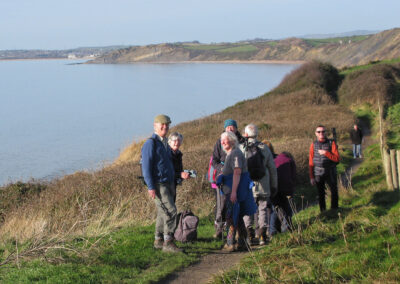 Photo of walkers approaching Osmington along the coast path – January 25, 2025