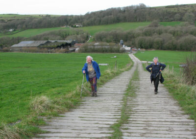 Photo of walkers on the ascent from Poxwell Lower Dairy Farm – January 25, 2025