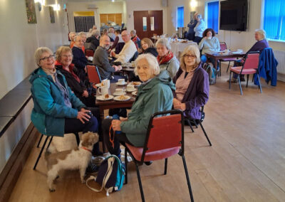 Photo of walkers enjoying tea and cake at Bloxworth Village Hall after the walk – February 12, 2025