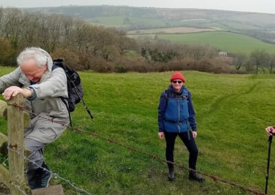 Photo of walkers negotiating Orchard Hill stile – February 19, 2025